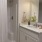 Spacious bathroom with large mirror and wood accents